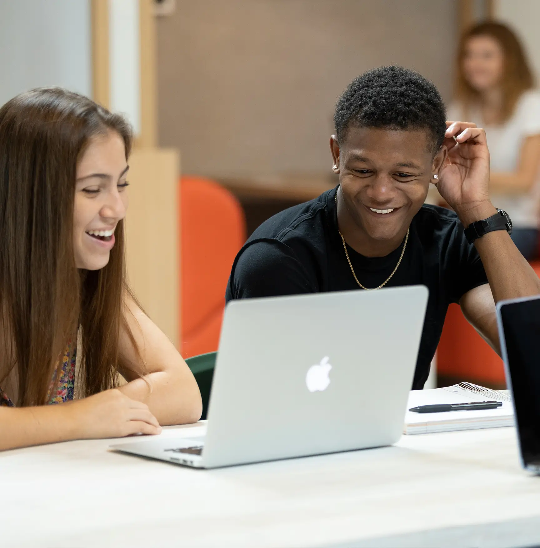 people looking at a laptop