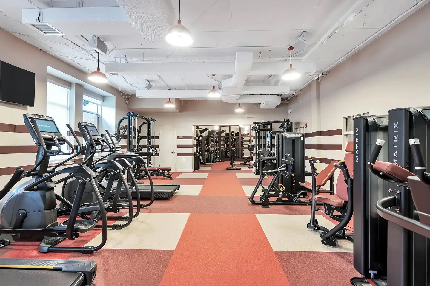 Student apartment gym with a variety of exercise machines